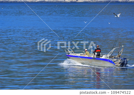 Tranquil Fishing Experience: Fishermen on an Aluminum Boat in the Norwegian Sea 109474522