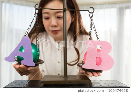 Woman comparing A and B Woman comparing A and B 109474658