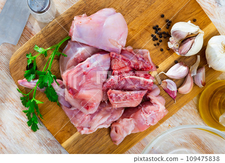 Portioned rabbit legs and saddle with herbs and spices 109475838
