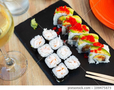 Set of different types of sushi served on board 109475873