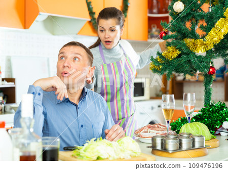 Unhappy woman quarreling with husband during cooking 109476196