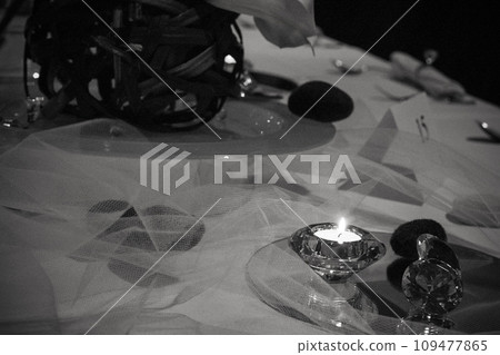 Elegance in Monochrome: A Candlelit Dinner Setting 109477865