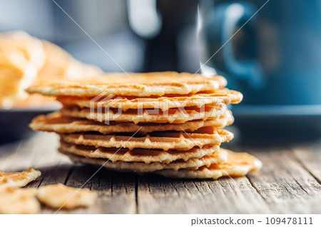 Round waffle biscuits on wooden table. 109478111