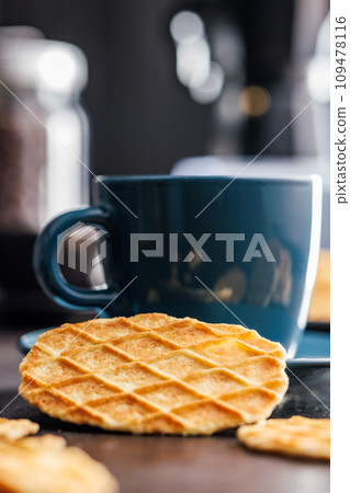 Round waffle biscuits on kitchen table. 109478116