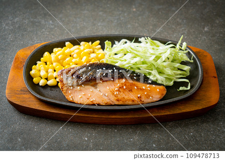 grilled salmon fillet steak on hot plate 109478713