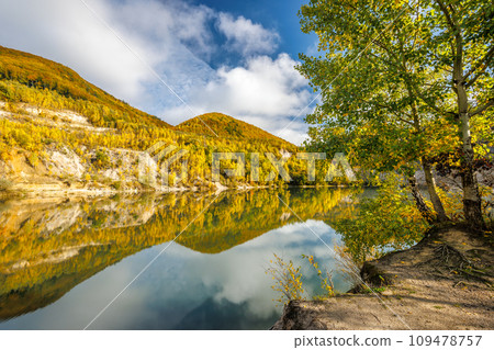 Autumn landscape with reflection of colorfull hills in the lake. 109478757
