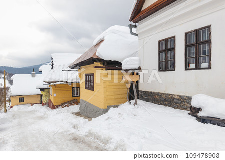 Folk architecture in snowy winter landscape. 109478908