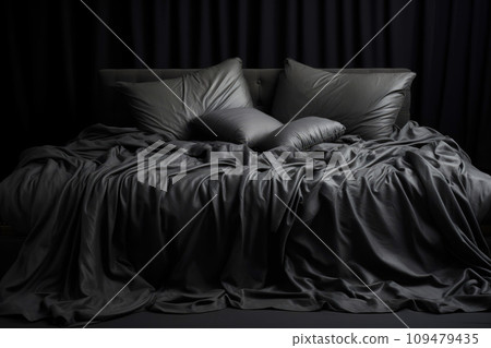 Black crumpled bed linen on the bed with pillows and a blanket 109479435