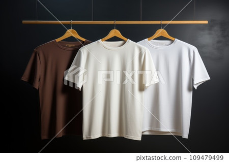 Layout of white and brown T-shirts on a hanger Layout of white and brown T-shirts on a hanger 109479499
