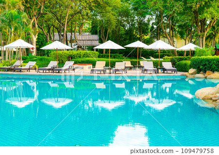 Umbrella and chair around swimming pool in resort hotel for leisure travel and vacation neary sea ocean beach Umbrella and chair around swimming pool in resort hotel for leisure travel and vacation neary sea ocean beach 109479758