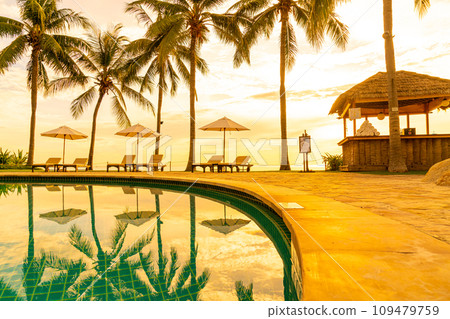Umbrella and chair around swimming pool in resort hotel for leisure travel and vacation neary sea ocean beach Umbrella and chair around swimming pool in resort hotel for leisure travel and vacation neary sea ocean beach 109479759