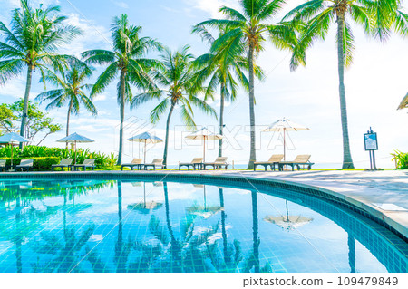 Beautiful umbrella and chair around swimming pool in hotel and resort 109479849