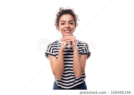 young slender caucasian woman with curly black hair is wearing a striped black and white t-shirt 109480146