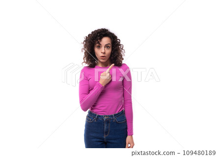 young curly brunette lady is dressed in a trendy lilac turtleneck on a white background 109480189