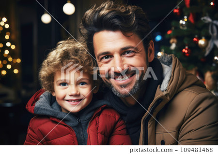 Dad hugs his son against the background of a Christmas tree 109481468