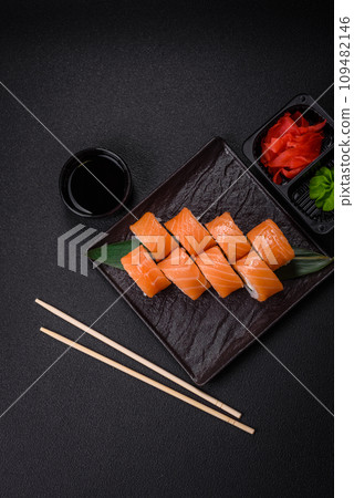 Delicious Philadelphia sushi roll with salmon, shrimp, cucumber and cream cheese Delicious Philadelphia sushi roll with salmon, shrimp, cucumber and cream cheese 109482146