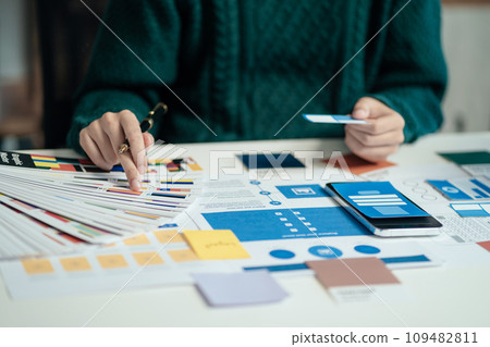 Creative male web designer planning application development for web mobile phone at modern workplace. 109482811