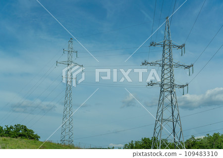 High voltage towers with sky background. Power line support with wires for electricity transmission. High voltage grid tower with wire cable at distribution station. Energy industry, energy saving 109483310