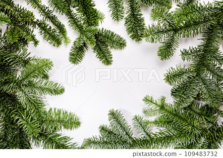 Christmas background fir branches frame on white. Flat lay, top view, copy space. Winter holidays, New Year. Christmas background fir branches frame on white. Flat lay, top view, copy space. Winter holidays, New Year. 109483732