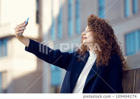 Woman makes selfie outdoor 109484274