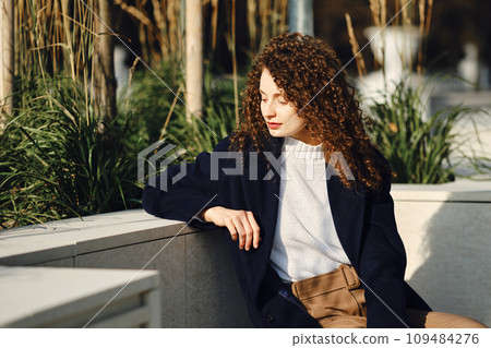City portrait of pensive woman on a bench 109484276