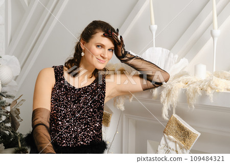 Cute woman sits by the fireplace 109484321