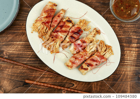Enoki mushroom appetizer fried in bacon Enoki mushroom appetizer fried in bacon 109484380