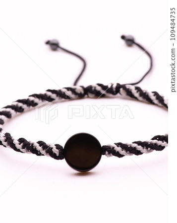 Buddhist bracelet shamballa with gems on a white background 109484735