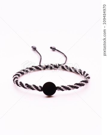 Buddhist bracelet shamballa with gems on a white background 109484970