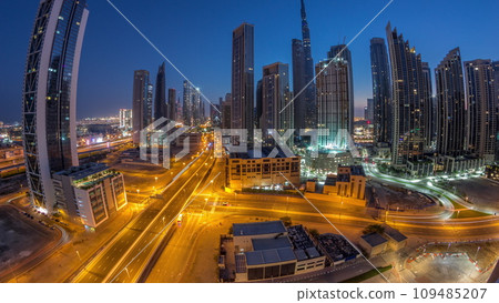 Aerial panorama of Dubai Downtown skyline with many towers night to day timelapse. 109485207