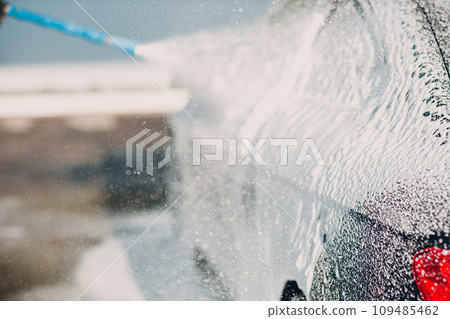 Worker washing car at self-service car wash Worker washing car at self-service car wash 109485462
