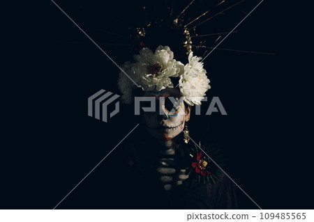 Woman with mexican skull halloween makeup on face. Day of the dead aka Dia de los Muertos and halloween concept. Woman with mexican skull halloween makeup on face. Day of the dead aka Dia de los Muertos and halloween concept. 109485565