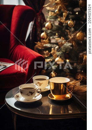 A coffee table with Xmas decor on a background of a sofa and a Christmas tree in the room. A coffee table with Xmas decor on a background of a sofa and a Christmas tree in the room. 109485924
