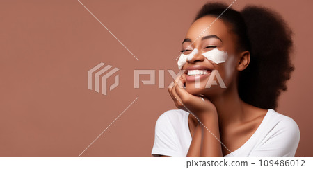 AI-generated content. Skin care concept - beautiful laughing asian female with cream ob her cheekbones 109486012