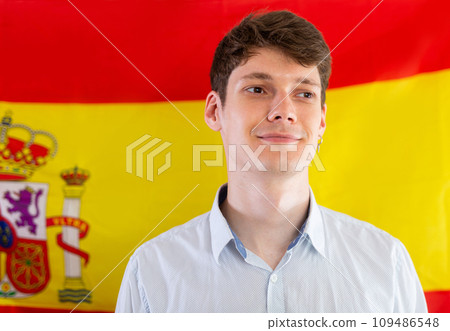 Portrait of positive student against background of flag of Spain 109486548