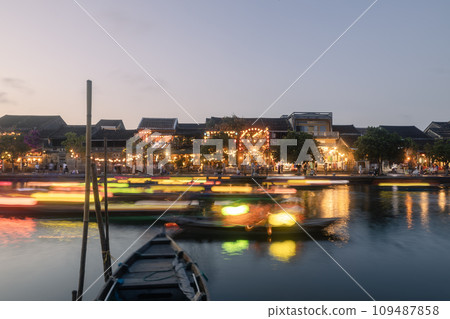 Traditional boats with lanterns in long exposure in Hoi An. 109487858