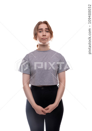 Tired Caucasian fair-haired teenage girl in a gray T-shirt close-up 109488032