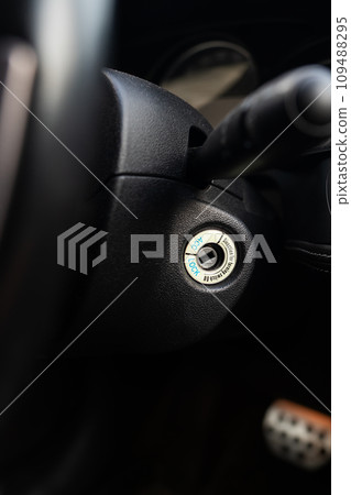 Close-up of a car ignition keyhole with a blurred dashboard background. Close-up of a car ignition keyhole with a blurred dashboard background. 109488295