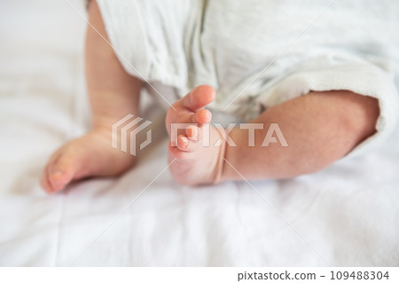 Small feet of a newborn baby. The concept of motherhood, breastfeeding. 109488304
