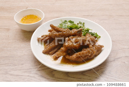 steamed chicken foot in sweet red soybean gravy on plate dipping chili sauce steamed chicken foot in sweet red soybean gravy on plate dipping chili sauce 109488661