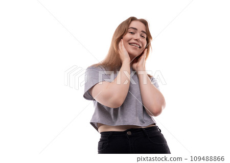 Portrait of a charming teenage girl with braces in a gray T-shirt on a white background 109488866