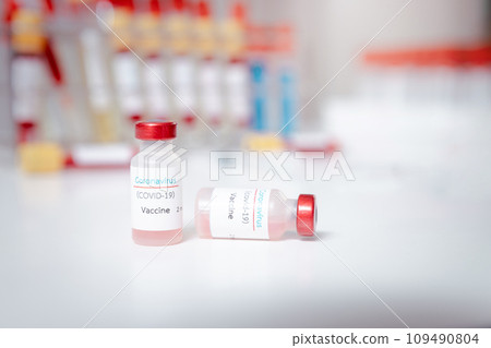 Sample of coronavirus vaccine (COVID-19) on work table in a medical lab. 109490804
