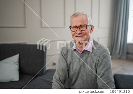 Portrait of confident stylish European middle aged senior man at home. Older mature 70s man smiling. Happy attractive senior grandfather looking camera close up face headshot portrait. Happy people 109491210