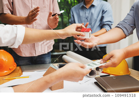 Real Estate Brokers and Customers Entering Home Sale Contracts. Buying and selling houses and real estate prices concept. Real Estate Brokers and Customers Entering Home Sale Contracts. Buying and selling houses and real estate prices concept. 109491318