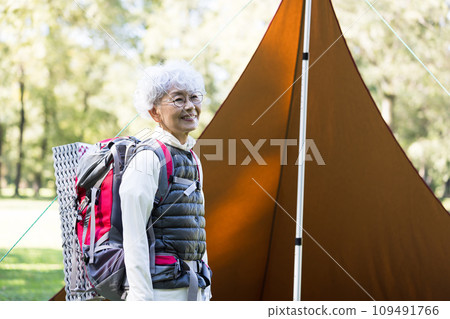 A woman in her 60s enjoying camping A woman in her 60s enjoying camping 109491766
