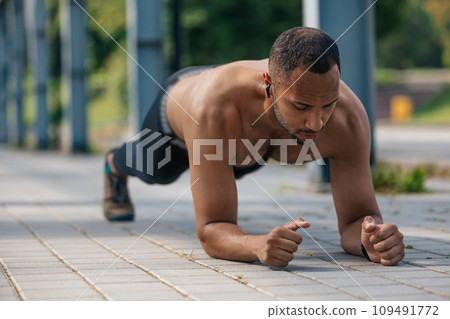 Young well-built african american man standing in plank 109491772
