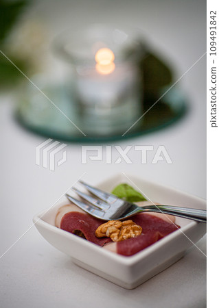 Refined Bite: Gourmet Hors d'Oeuvre with Candlelit Backdrop Refined Bite: Gourmet Hors d'Oeuvre with Candlelit Backdrop 109491842