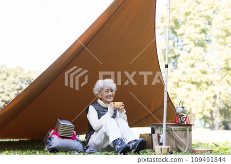 A woman in her 60s enjoying camping A woman in her 60s enjoying camping 109491844
