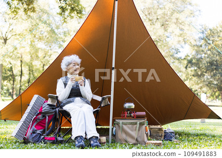 A woman in her 60s enjoying camping A woman in her 60s enjoying camping 109491883