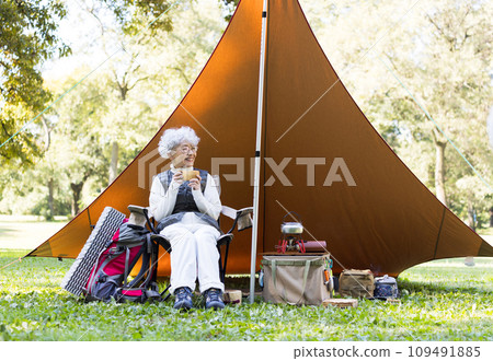 A woman in her 60s enjoying camping A woman in her 60s enjoying camping 109491885